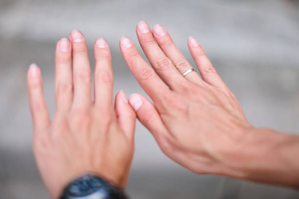 istock Women's hands are raised with their fingers up, in front of them. 1484219751