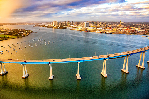 The Coronado - San Diego Bay Bridge connecting the cities of Coronado and San Diego spanning the San Diego Bay shot from an altitude of about 600 feet during a helicopter photo flight with the skyline of the city of San Diego in the background.