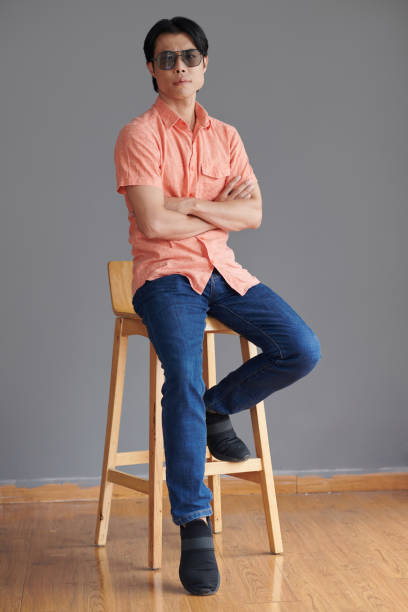 istock Young Man Sitting on Chair 1484222969