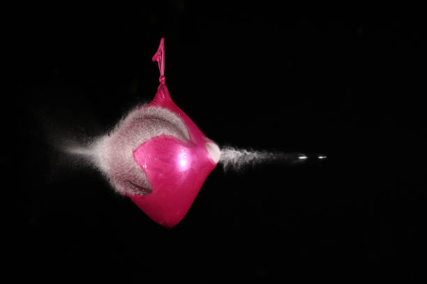 A splash of vivid red liquid caught mid-air, forming an abstract shape with droplets scattering around against a clean white background, frozen in motion with striking detail and texture.