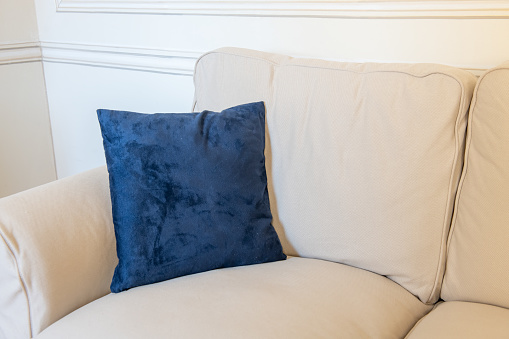 Blue velvet pillows on a modern sofa.