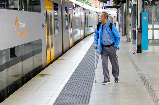 Sydney, Australia - April 22, 2023: Train leaving Central station with one passenger behind
