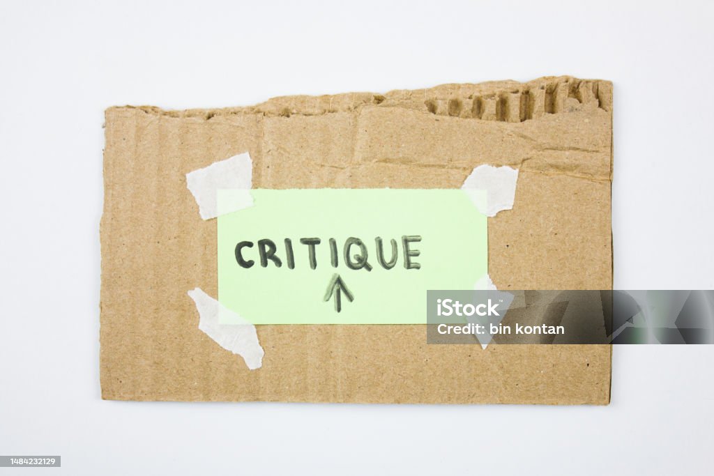 Critique word text on paper with cardboard. Concept abstract CRITIQUE Advice Stock Photo