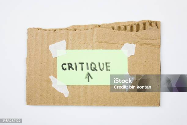 Critique Word Text On Paper With Cardboard Concept Abstract Critique Stock Photo - Download Image Now