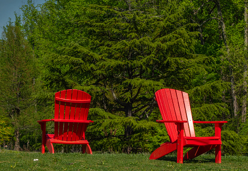 Two red chairs on top of a hill