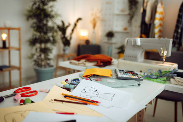 istock Sewing machine and accessories on table in dressmaking workshop with no people 1484235139