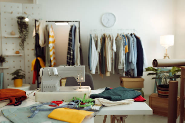 istock Sewing machine and accessories on table in dressmaking workshop with no people 1484235145