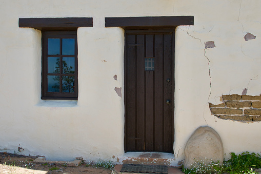 Vintage adobe building with period details overlooks the beach below