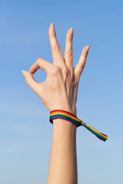 istock Woman's hand okay gesture with LGTB rainbow bracelet for Pride Day 1484241868