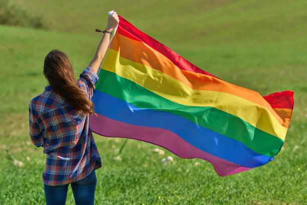 istock Woman with Rainbow flag on pathway 1484241875