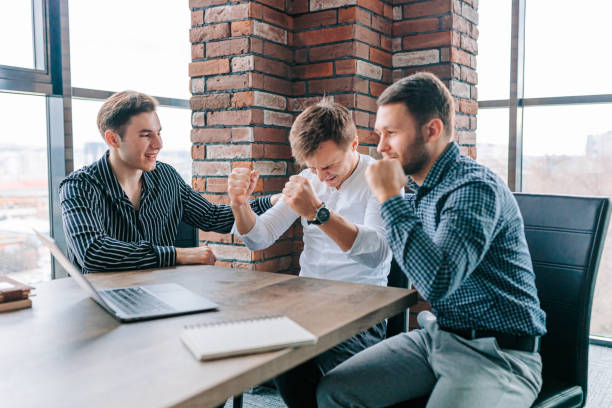 istock Joyful colleagues celebrating their successful teamwork on a laptop project 1484245104