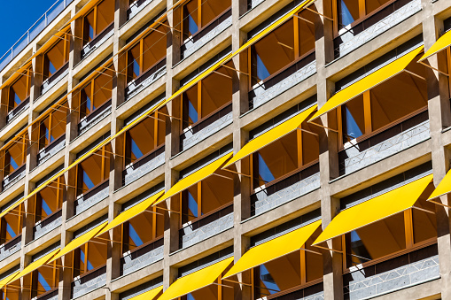 Copenhagen, Denmark An office building with yellow awnings over the windows to protect from the sun.