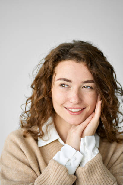 istock Pretty young woman looking away dreaming thinking isolated on white, vertical. 1484245559
