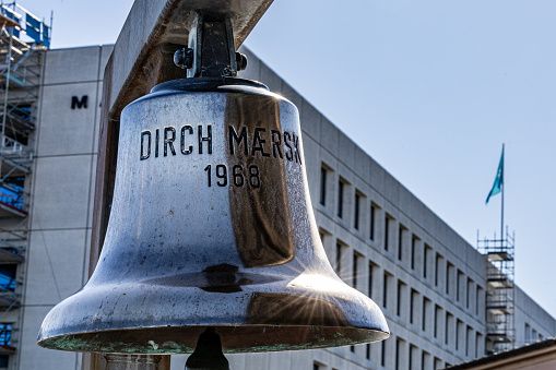 Copenhagen, Denmark April 3, 2023 A Maersk ship bell hanging at corporate headquarters from 1968.