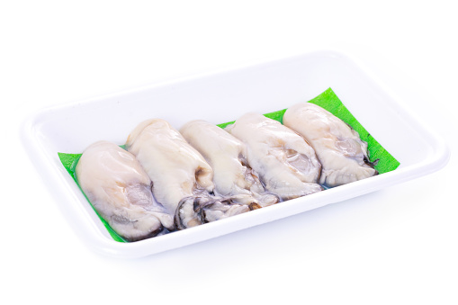 Freshness Raw Shucked Oysters in a Foam Container. White Background