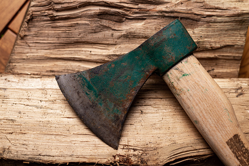 Axe and log on dark background. Firewood harvesting for winter concept