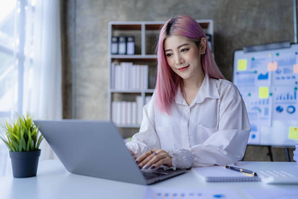 istock Young Asian accountant working in a financial office Manage sales reports using calculator with laptop and financial documents. 1484259643