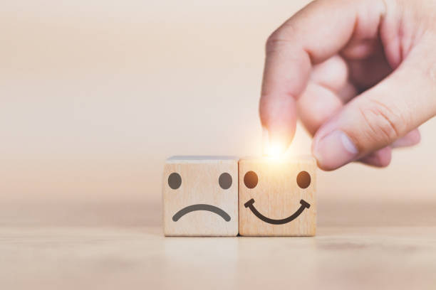 istock Customer service and Satisfaction concept man's hand is building a cube wood  in the satisfaction rating the popular service company allows customers in order to improve and develop the organization 1484261661