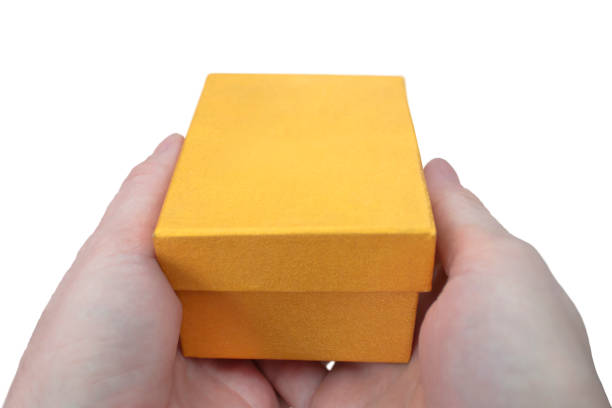 istock Gift box in gold color in hands. 1484262625