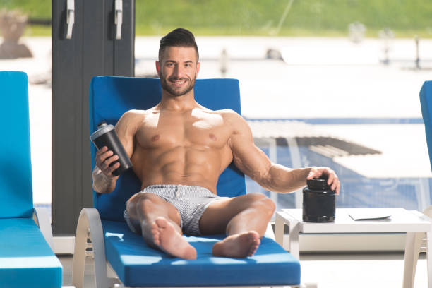 istock Man Resting on Lounger With Supplements and Shaker 1484263668
