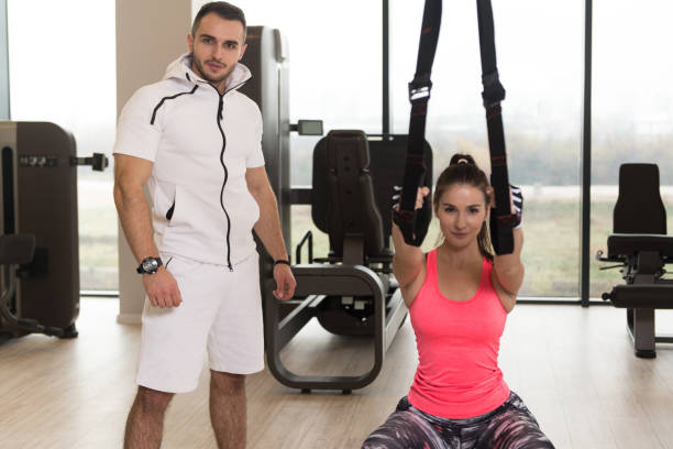 istock Fit Couple Training Together With Trx Straps 1484267007