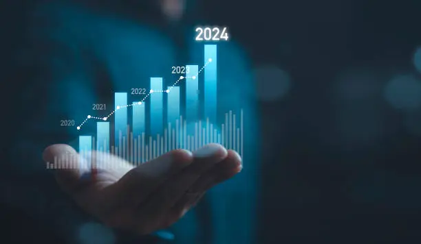 Photo of Businessman holding glowing virtual technical graph and chart for analysis stock market in 2024, technology investment and value investment concept.