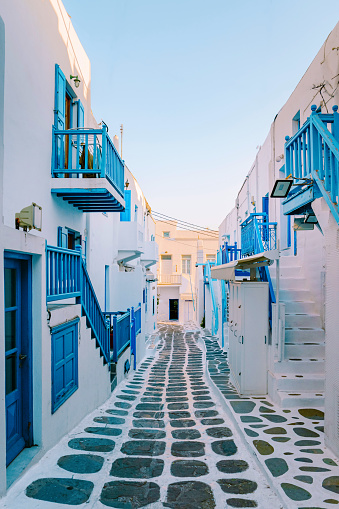 Mykonos Greece, colorful streets of the old town of Mykonos, Traditional narrow street with blue doors and white walls, Mykonos town Greece during summer