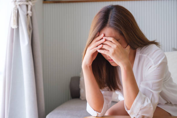 istock A young woman feeling sad and stressed, sick and headache at home 1484283314