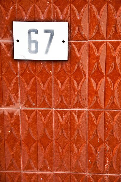 istock 67, Street Number On The Wall 148428583
