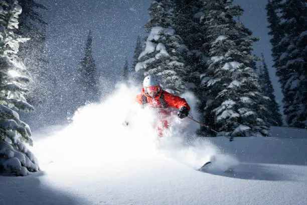 Skier blowing through powder snow. 