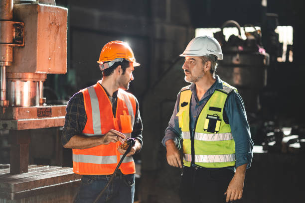 istock professional technician engineer with safety working in industrial manufacturing factory, checking equipment of machinery production technology construction operating, success commitment determination 1484291018