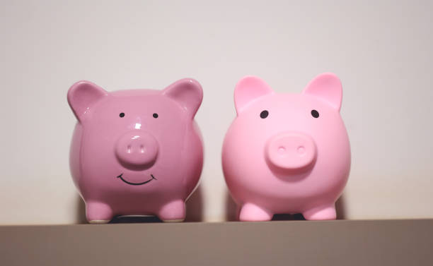 istock Two piggy banks on a wall shelf. 1484291468