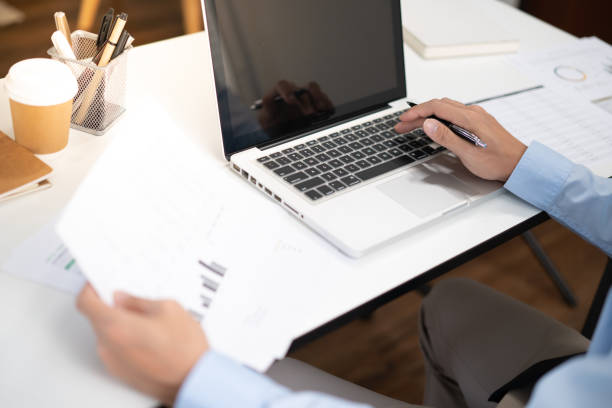 istock Business man working by using laptop computer Hands typing on a keyboard. Professional investor working new start up project. business planning in office. Technology business 1484294702