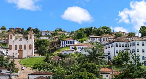 Photo of View to historic mining town Serro nestled on a hill, blue sky and white clouds, Minas Gerais, Brazil