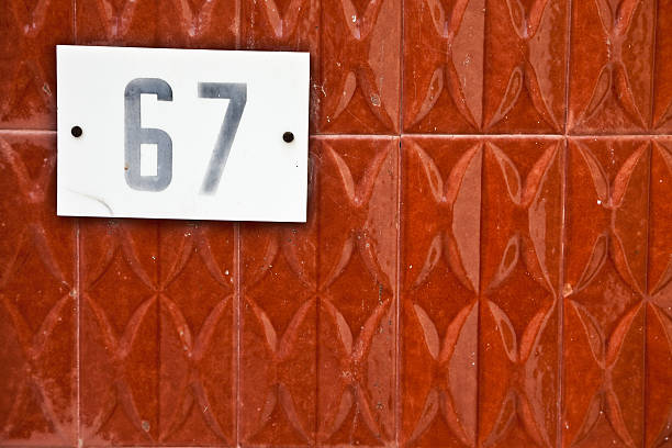 istock 67, Street Number On The Wall 148429698