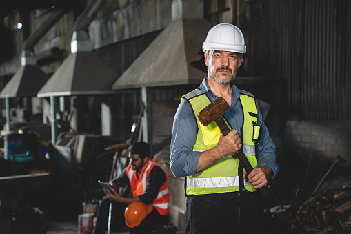 men at work concept, confident engineer person man occupation or professional manufacturing technician foreman portrait with industry safety helmet, inspector job manager to work in factory warehouse