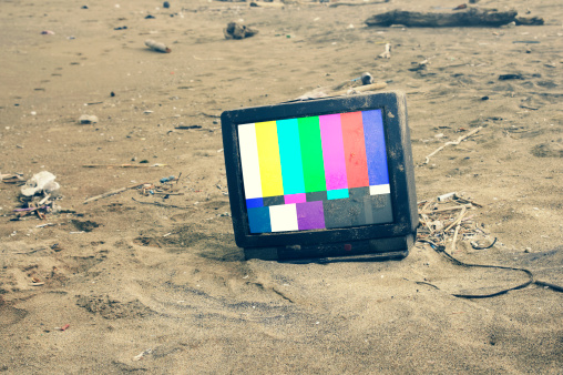 old TV playing color bars in desert