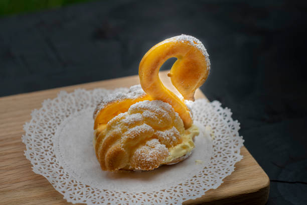 swan dessert made from choux paste nad diplomatic cream