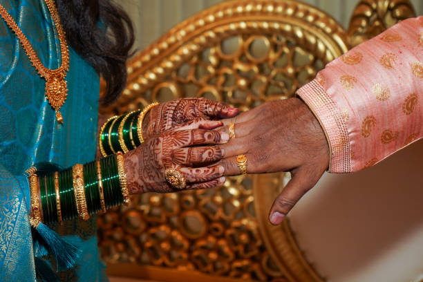 istock Bride putting ring in grooms finger 1484306677