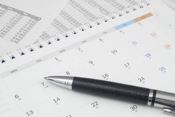 istock Black metal pen on calendar page 1484307624