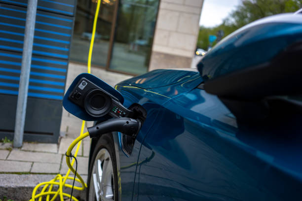 istock electric car is charging at car park focus on foreground horizontal still 1484308044