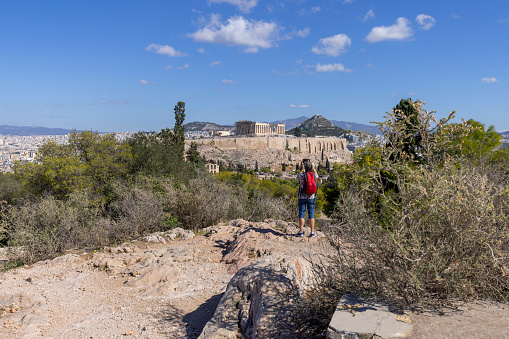 Athens, Greece - October 17, 2022: View of the Acropolis of Athens and Mount Lycabettus from Muse Hill on a background of blue sky
