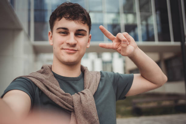 istock Handsome Caucasian teenager taking selfie outside 1484310546