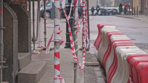 istock Outdoor Construction Works Portable Red and White Plastic Safety Barrier Blocks Installed by Street Curb 1484310583