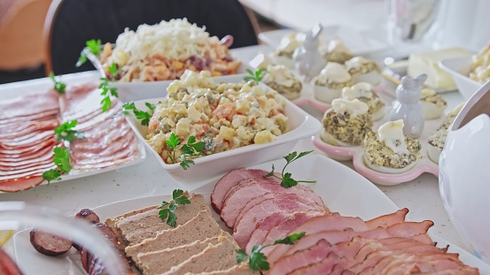 Vegetable Salad Stuffed Deviled Eggs Sliced Ham Meat and Sausage Prepared for Family Gathering Event during Easter Holidays
