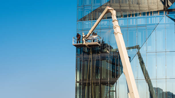 istock Cleaner worker using a cherry picker to clean a glas facade of a contemporary office building 1484311568