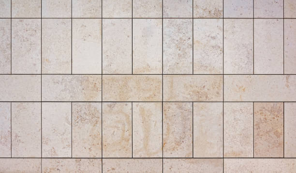 istock texture of a tiled beige stone wall as background, natural stone wall texture as background. 1484311600