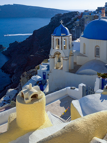 Bell Tower and Blue domed church high on the edge of the volcanic caldera on the Greek island of Santorini (Thira) in the southern Aegean Sea.