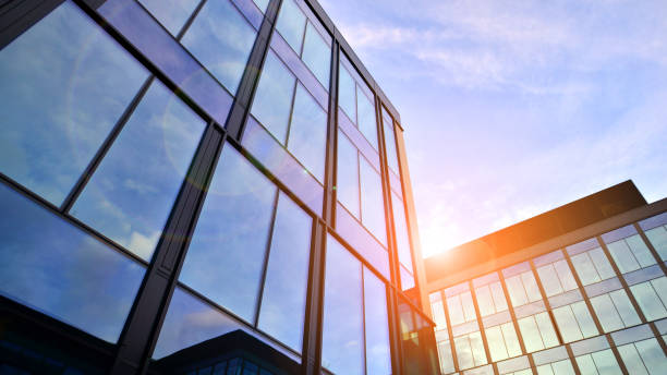 istock Glass modern building with blue sky background. Low angle view and architecture details. 1484315475