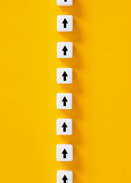 istock Business performance improvement. Following a direction or path. Arrow symbols on white cubes on yellow background. 1484319507